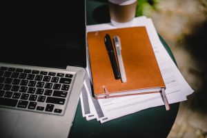 Agenda next to a laptop computer.